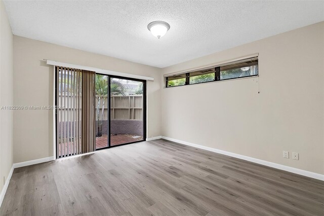 608 Saint Andrews Rd Unit 46, Hollywood, FL 33021 - empty room featuring wood finished floors and a textured ceiling