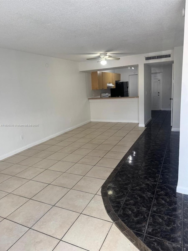 4045 NW 19th St, Lauderhill, FL 33313 - unfurnished living room with ceiling fan, a textured ceiling, and light tile patterned floors