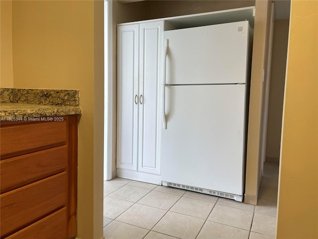 8325 Sunrise Lakes Blvd Unit 305, Sunrise, FL 33322 - kitchen featuring freestanding refrigerator and light tile patterned floors