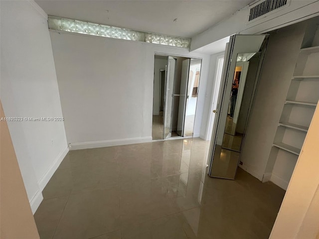 16465 NE 22nd Ave Unit 417, North Miami Beach, FL 33160 - empty room with tile patterned flooring and baseboards