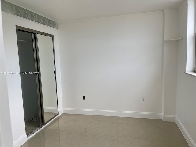 16465 NE 22nd Ave Unit 417, North Miami Beach, FL 33160 - unfurnished bedroom featuring a closet and baseboards