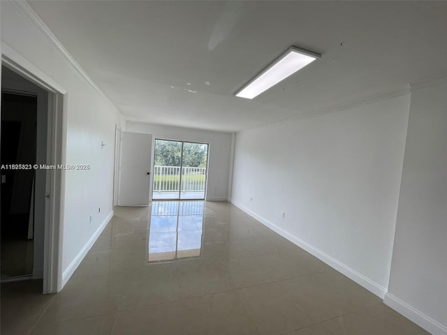16465 NE 22nd Ave Unit 417, North Miami Beach, FL 33160 - tiled empty room with crown molding and baseboards