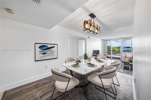 10700 SW 108th Ave Unit C316, Miami, FL 33176 - dining room with wood finished floors, a chandelier, and a textured ceiling