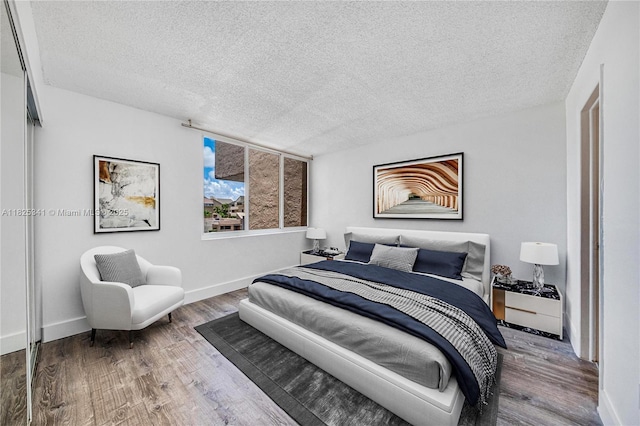 10700 SW 108th Ave Unit C316, Miami, FL 33176 - bedroom featuring a textured ceiling and wood finished floors