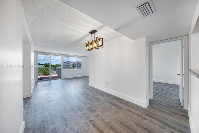 10700 SW 108th Ave Unit C316, Miami, FL 33176 - unfurnished living room with dark wood-style floors, a chandelier, and a textured ceiling