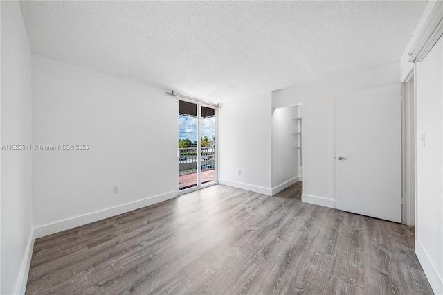 10700 SW 108th Ave Unit C316, Miami, FL 33176 - spare room featuring wood finished floors and a textured ceiling