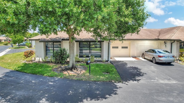 4764 Greentree Cres Unit A, Boynton Beach, FL 33436 - view of front of house featuring driveway, stucco siding, an attached garage, and a shingled roof