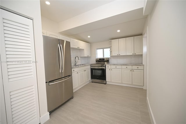 2949 SW 14th St, Miami, FL 33145 - kitchen with stainless steel appliances, tasteful backsplash, white cabinets, recessed lighting, and light stone countertops