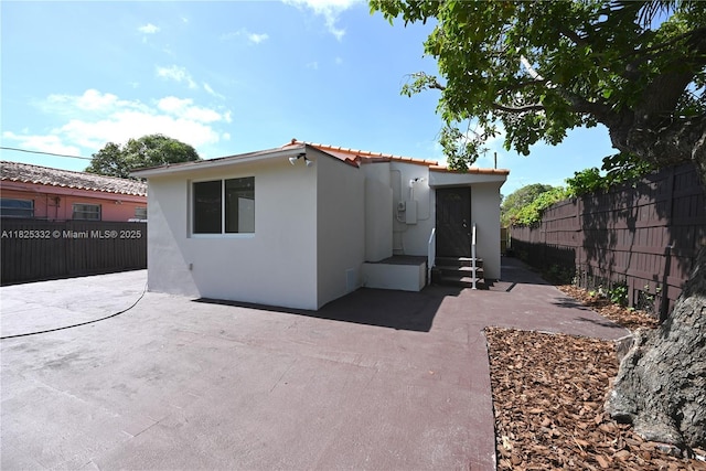 2949 SW 14th St, Miami, FL 33145 - rear view of property featuring stucco siding and a patio area