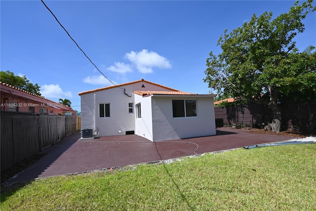 2949 SW 14th St, Miami, FL 33145 - rear view of house featuring stucco siding, a patio area, a fenced backyard, and a tiled roof