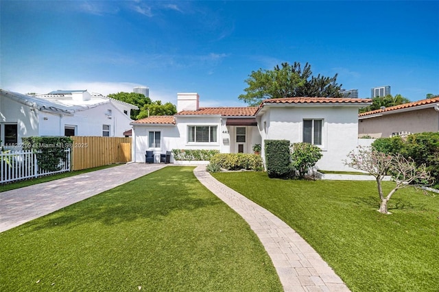 443 SW 18th Rd, Miami, FL 33129 - mediterranean / spanish house with a tiled roof, stucco siding, a chimney, and concrete driveway