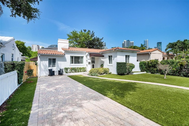 443 SW 18th Rd, Miami, FL 33129 - mediterranean / spanish-style house with a tile roof, stucco siding, and a chimney