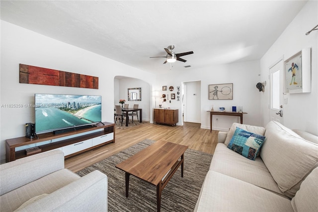 443 SW 18th Rd, Miami, FL 33129 - living area with arched walkways, light wood-style flooring, and a ceiling fan