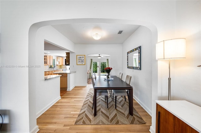 443 SW 18th Rd, Miami, FL 33129 - dining space with arched walkways, light wood-style flooring, and ceiling fan