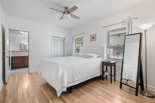 443 SW 18th Rd, Miami, FL 33129 - bedroom with light wood-style flooring, a closet, connected bathroom, and a ceiling fan