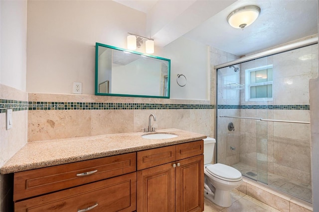 443 SW 18th Rd, Miami, FL 33129 - full bath with vanity, a shower stall, tile walls, tile patterned flooring, and a wainscoted wall