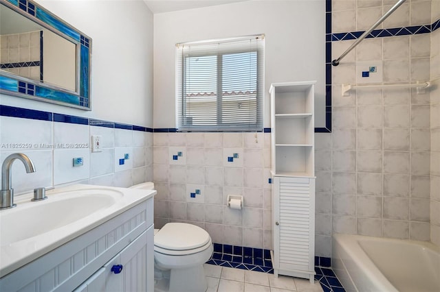 443 SW 18th Rd, Miami, FL 33129 - bathroom featuring tile walls, tile patterned floors, a tub, and vanity