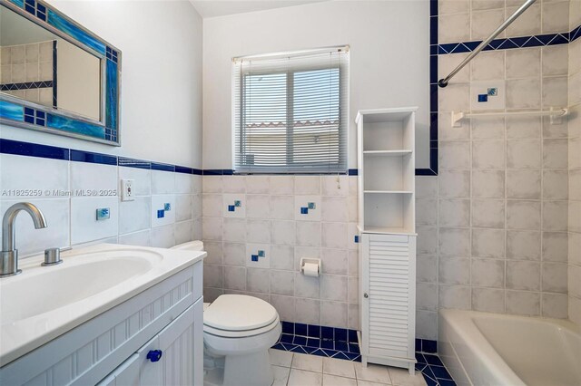 443 SW 18th Rd, Miami, FL 33129 - bathroom featuring tile walls, tile patterned floors, a tub, and vanity