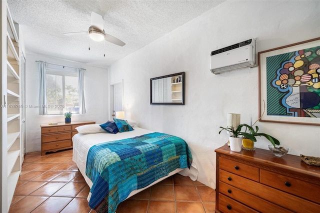 443 SW 18th Rd, Miami, FL 33129 - bedroom with a wall unit AC, light tile patterned flooring, ceiling fan, and a textured ceiling