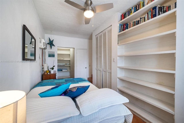 443 SW 18th Rd, Miami, FL 33129 - bedroom featuring a textured ceiling, a closet, a ceiling fan, and a wall mounted air conditioner