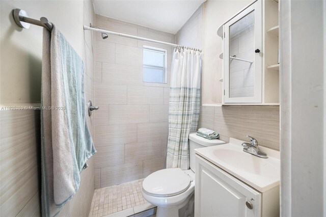 443 SW 18th Rd, Miami, FL 33129 - full bathroom featuring vanity, tiled shower, and tile walls