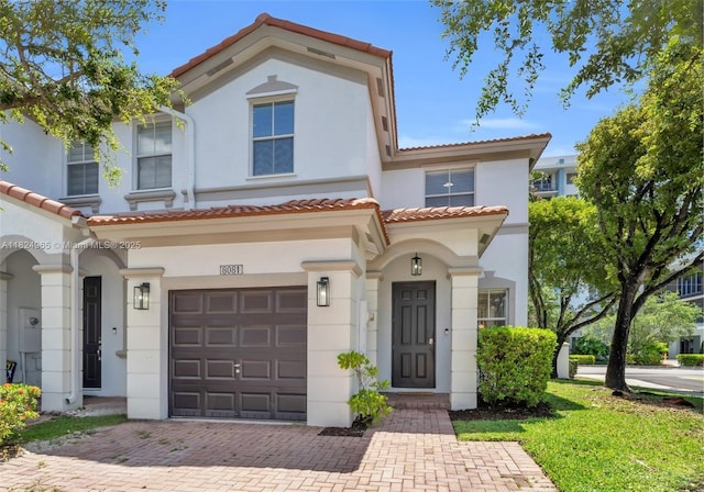 8081 NW 107th Ct, Doral, FL 33178 - view of front of property with an attached garage, stucco siding, a tiled roof, and decorative driveway
