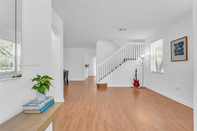 8081 NW 107th Ct, Doral, FL 33178 - unfurnished living room featuring wood finished floors and stairway