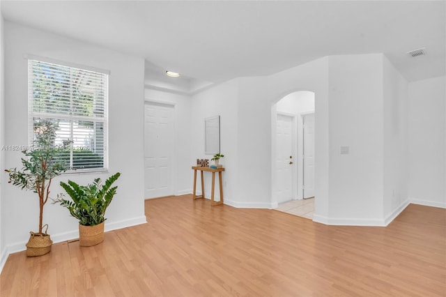 8081 NW 107th Ct, Doral, FL 33178 - spare room featuring arched walkways and light wood-type flooring