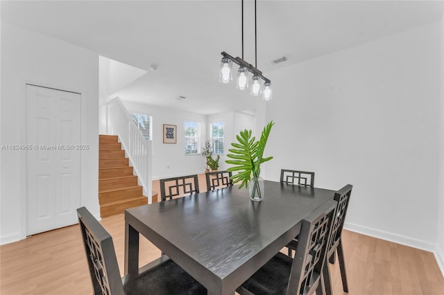 8081 NW 107th Ct, Doral, FL 33178 - dining space with light wood-style flooring and stairway