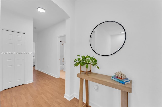 8081 NW 107th Ct, Doral, FL 33178 - hall featuring light wood finished floors and arched walkways