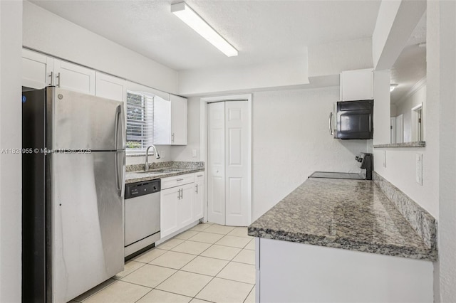 2817 SW 8th St, Fort Lauderdale, FL 33312 - kitchen with appliances with stainless steel finishes, white cabinetry, and light tile patterned floors