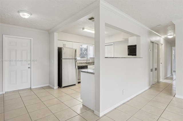 2817 SW 8th St, Fort Lauderdale, FL 33312 - kitchen featuring freestanding refrigerator, a textured ceiling, dishwasher, light tile patterned flooring, and white cabinets