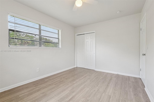 2817 SW 8th St, Fort Lauderdale, FL 33312 - unfurnished bedroom with wood finished floors, multiple windows, a closet, and a ceiling fan