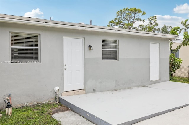 2817 SW 8th St, Fort Lauderdale, FL 33312 - doorway to property with a patio area and stucco siding