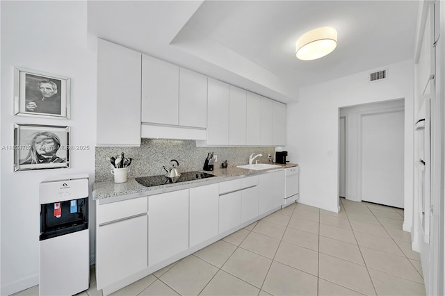 9601 Collins Ave Unit 809, Bal Harbour, FL 33154 - kitchen featuring black electric cooktop, decorative backsplash, white dishwasher, custom range hood, and white cabinets