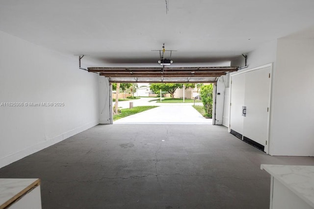 3420 NW 21st Ct, Coconut Creek, FL 33066 - garage featuring a garage door opener and baseboards
