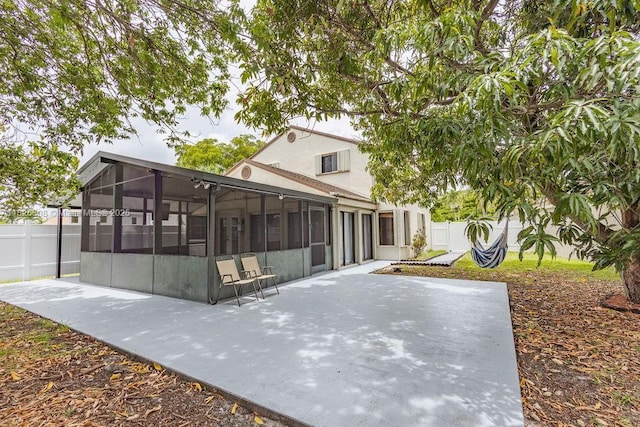 3420 NW 21st Ct, Coconut Creek, FL 33066 - back of property with a sunroom, a patio, a fenced backyard, and stucco siding