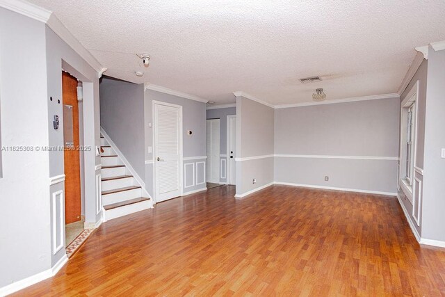 3420 NW 21st Ct, Coconut Creek, FL 33066 - empty room featuring light wood finished floors, stairs, crown molding, and a textured ceiling