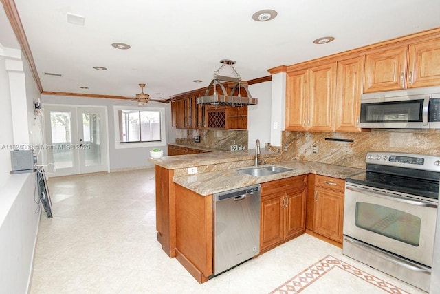 3420 NW 21st Ct, Coconut Creek, FL 33066 - kitchen with appliances with stainless steel finishes, ornamental molding, a peninsula, backsplash, and french doors