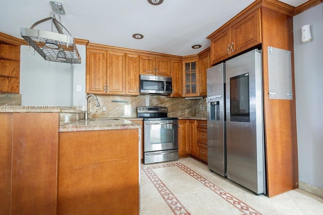 3420 NW 21st Ct, Coconut Creek, FL 33066 - kitchen with stainless steel appliances, brown cabinetry, and decorative backsplash