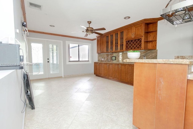 3420 NW 21st Ct, Coconut Creek, FL 33066 - kitchen featuring brown cabinets, ornamental molding, decorative backsplash, ceiling fan, and open shelves