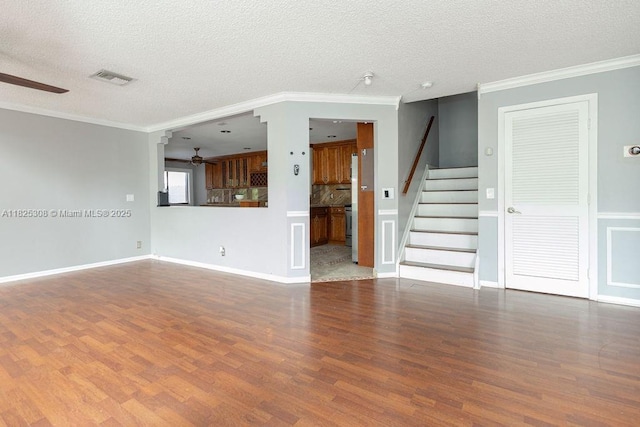 3420 NW 21st Ct, Coconut Creek, FL 33066 - unfurnished living room featuring a ceiling fan, wood finished floors, stairs, a textured ceiling, and ornamental molding