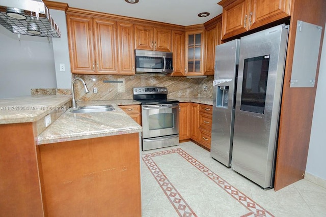 3420 NW 21st Ct, Coconut Creek, FL 33066 - kitchen with appliances with stainless steel finishes, brown cabinets, a peninsula, and decorative backsplash