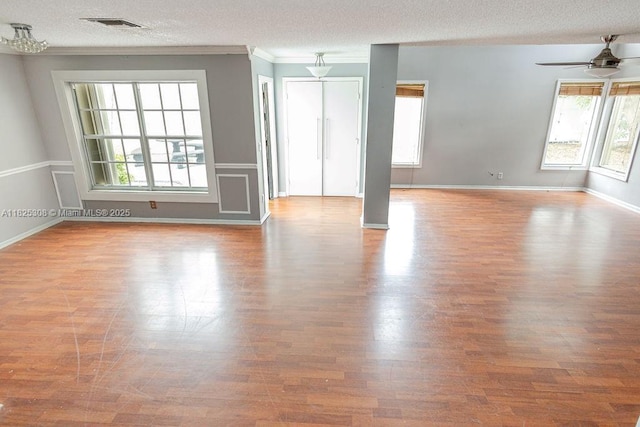 3420 NW 21st Ct, Coconut Creek, FL 33066 - empty room with ceiling fan, wood finished floors, a textured ceiling, and ornamental molding