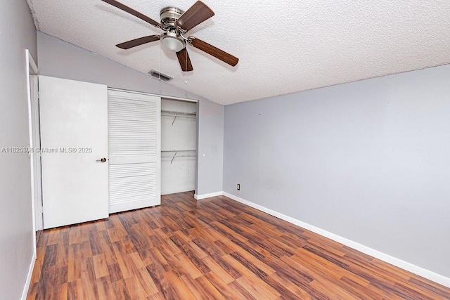 3420 NW 21st Ct, Coconut Creek, FL 33066 - unfurnished bedroom with lofted ceiling, wood finished floors, a closet, a textured ceiling, and ceiling fan