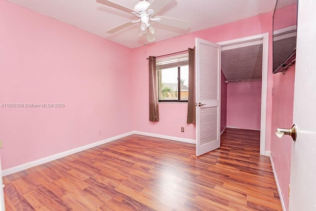 3420 NW 21st Ct, Coconut Creek, FL 33066 - empty room featuring wood finished floors, a ceiling fan, and a textured ceiling