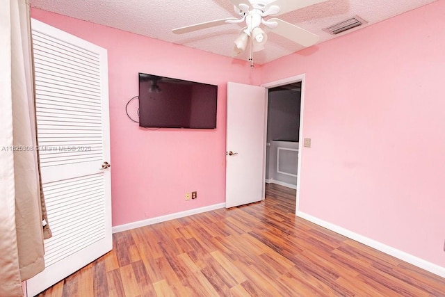 3420 NW 21st Ct, Coconut Creek, FL 33066 - unfurnished bedroom with light wood-type flooring, a textured ceiling, and ceiling fan