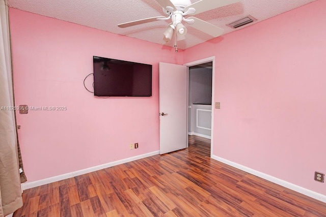 3420 NW 21st Ct, Coconut Creek, FL 33066 - unfurnished bedroom with wood finished floors, ceiling fan, and a textured ceiling