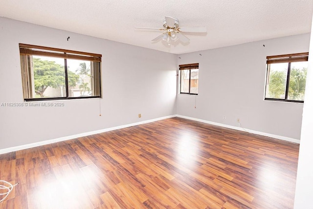 3420 NW 21st Ct, Coconut Creek, FL 33066 - empty room featuring healthy amount of natural light, wood finished floors, ceiling fan, and a textured ceiling