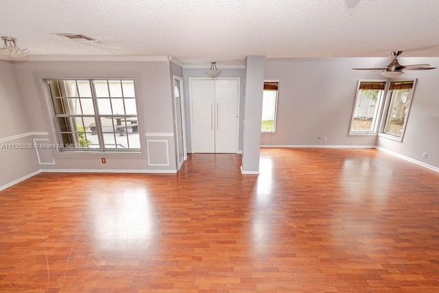 3420 NW 21st Ct, Coconut Creek, FL 33066 - empty room with light wood finished floors, a textured ceiling, a ceiling fan, and ornamental molding